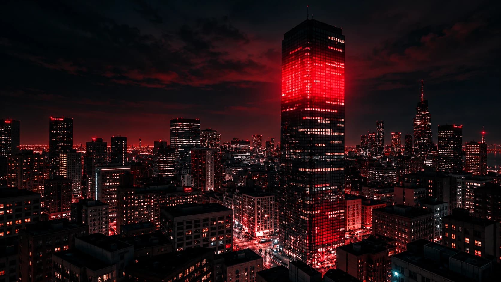 City skyline at dusk with red-lit towers